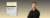 Hintergrund ist ein Farbverlauf von Schwarz zu Beige. Vordergrund: Links das Buchcover: "The Praxis of Collaborative Innovation" und rechts ein Bild des Autors.